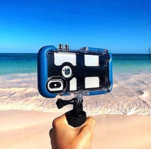 an iPhone in a waterproof case on a beach in Hawaii