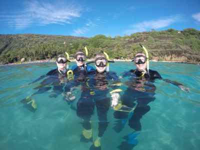 Group of 4 people snorkeling at Hanauma Bay with Pure Aloha Adventures in Oahu, Hawaii