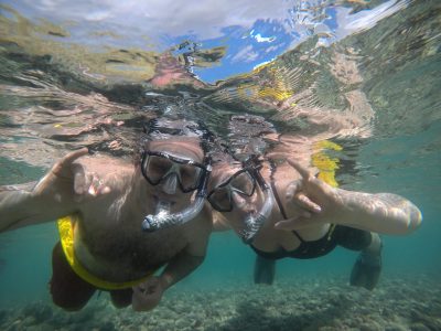 2 people snorkeling underwater with masks and snorkels