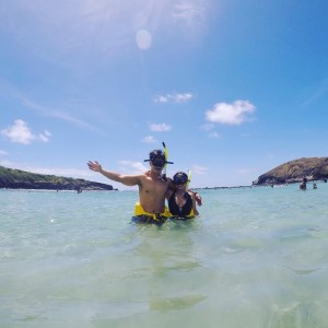 2 people in masks and snorkels standing in the water at Hanauma Bay in Hawaii